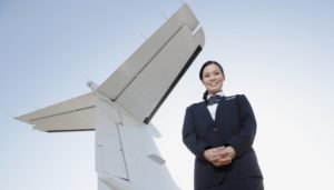Airline Stewardess Posed by Airplane